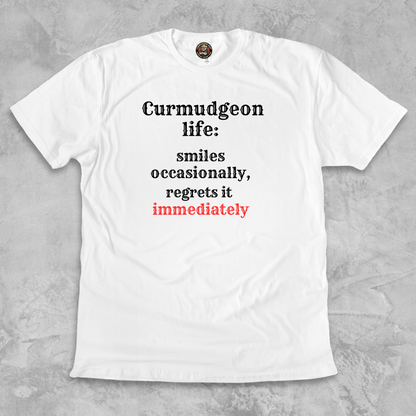 SMILES.™ – And Instantly Regrets It A tee for the man who accidentally showed emotion.