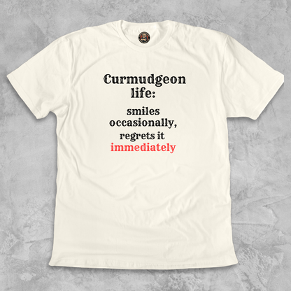 SMILES.™ – And Instantly Regrets It A tee for the man who accidentally showed emotion.