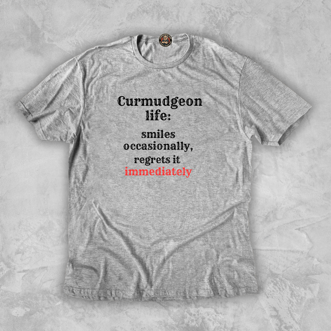 SMILES.™ – And Instantly Regrets It A tee for the man who accidentally showed emotion.