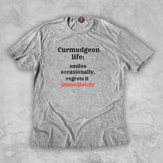 SMILES.™ – And Instantly Regrets It A tee for the man who accidentally showed emotion.