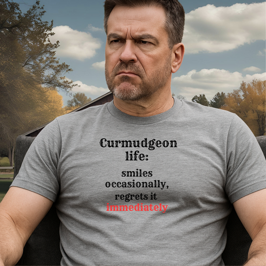 SMILES.™ – And Instantly Regrets It A tee for the man who accidentally showed emotion.